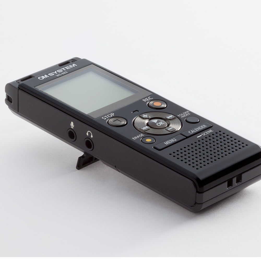 a black digital recorder sitting on top of a white table
